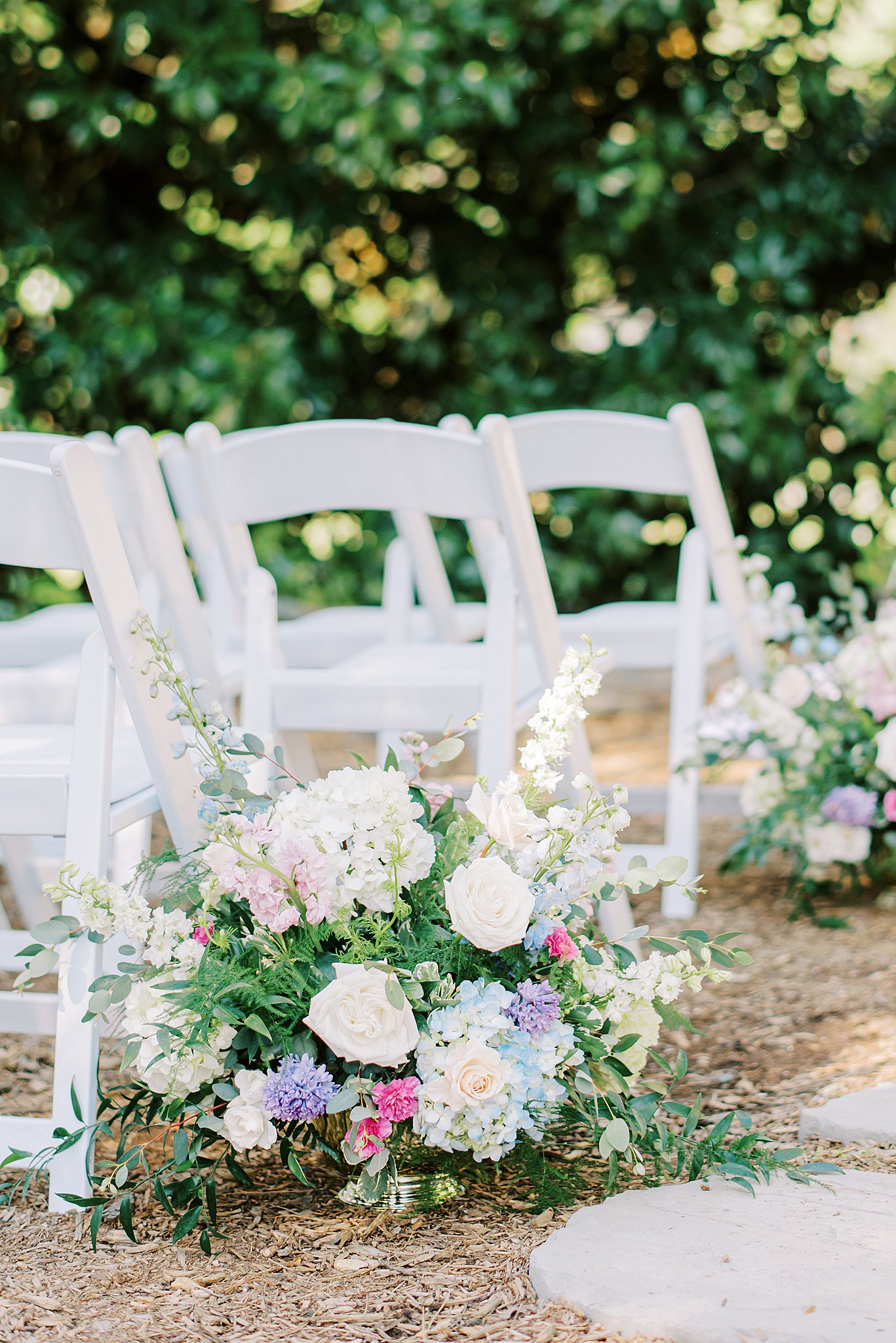 Details of white and pink floral arrangements at a wedding ceremony