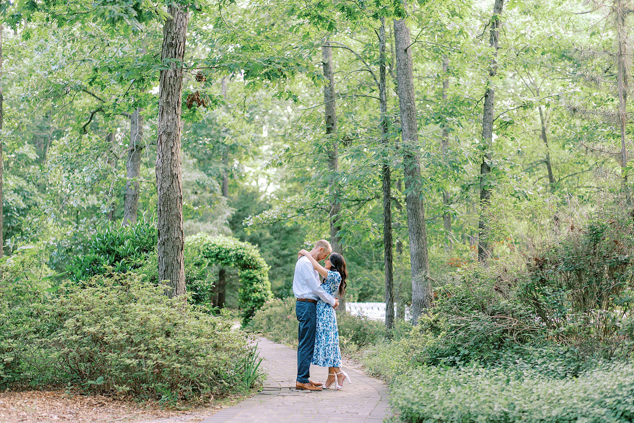 Newlyweds touch foreheads while hugging on a garden path Morning Glory Farm
