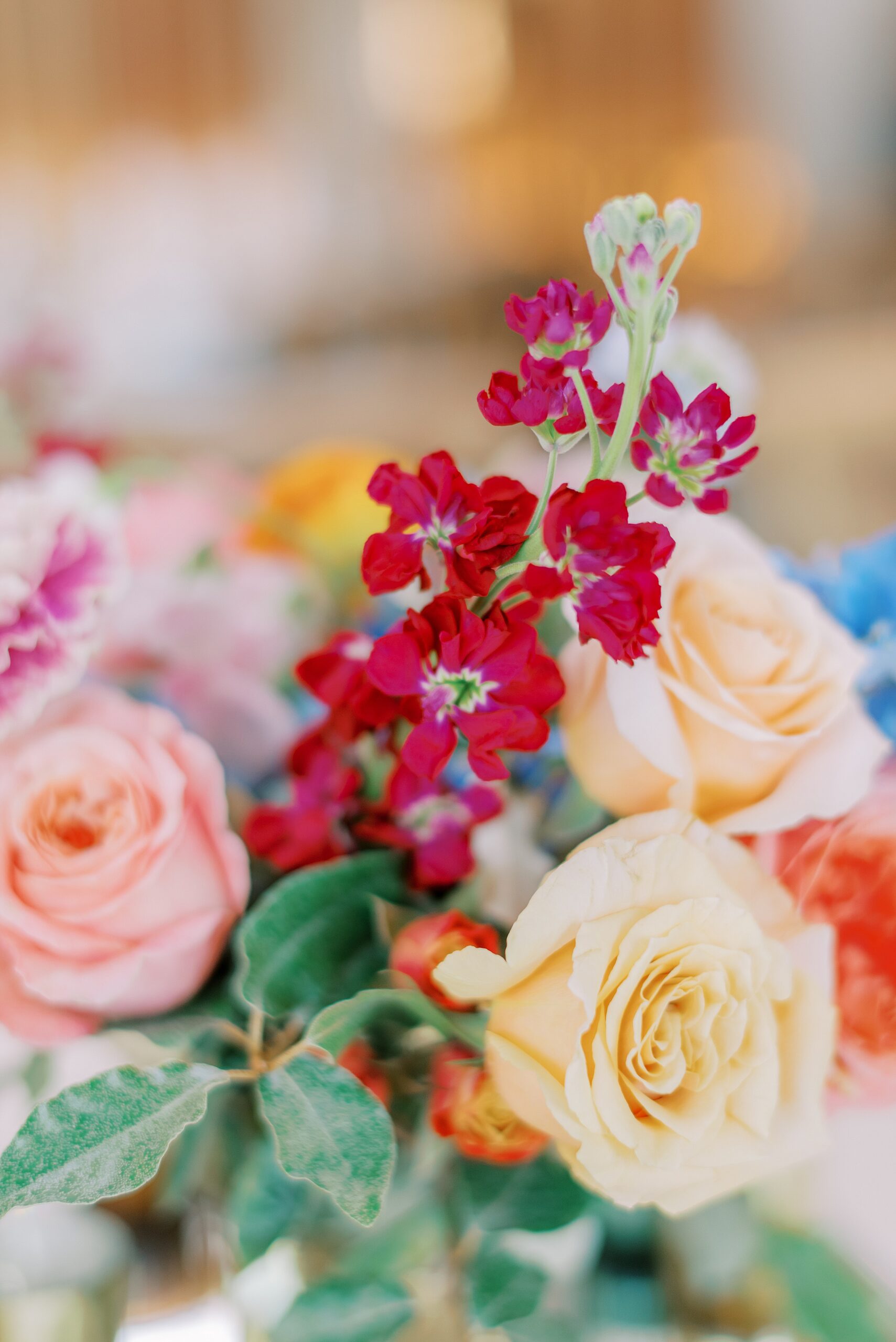 Details of a wedding centerpiece with colorful roses