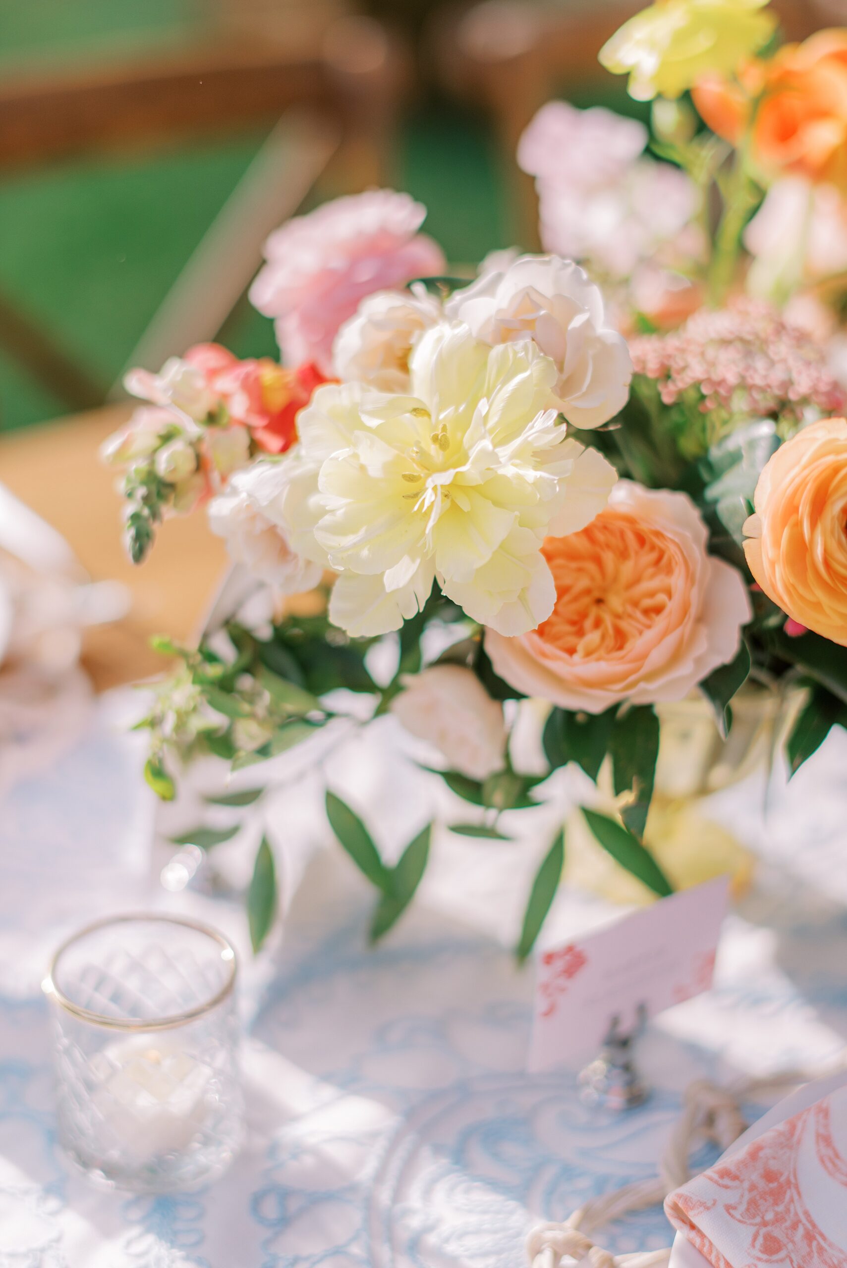 Details of a colorful outdoor table setting with flowers at a charlotte country club wedding